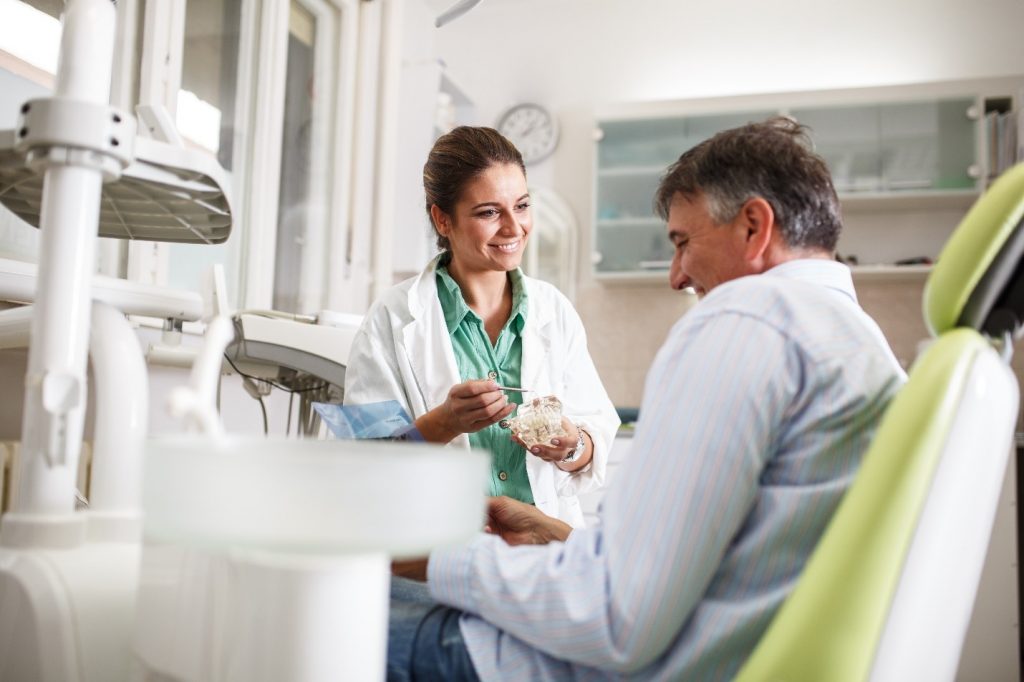 Dentist answering patient's questions about sedation dentistry