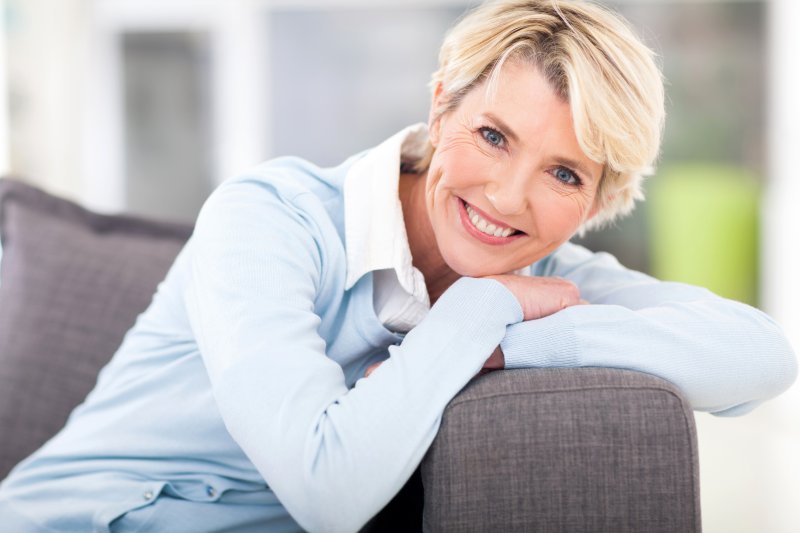 Smiling woman leaning on a couch